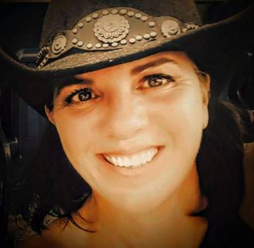Dede Johnson, smiling in a black cowboy hat